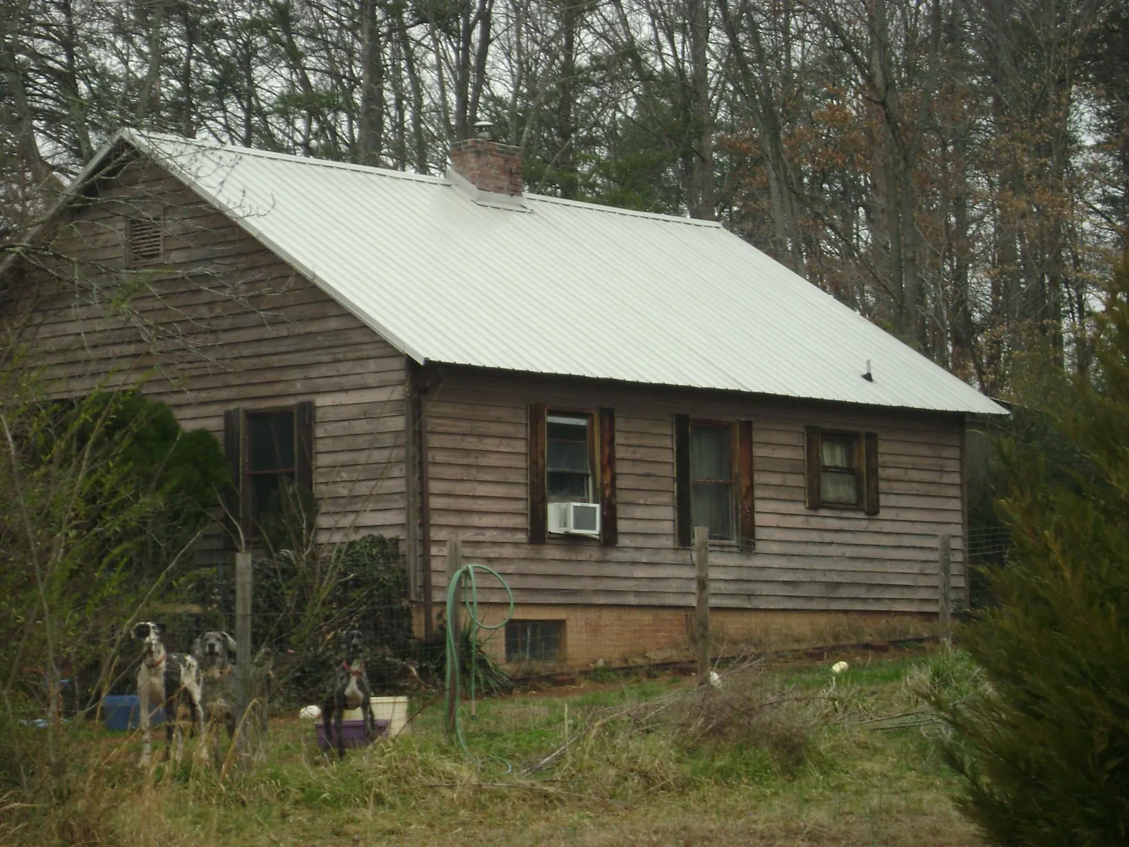 White metal roof on an old wood sided farmhouse, from a Metal Roof Installation job in Alleman